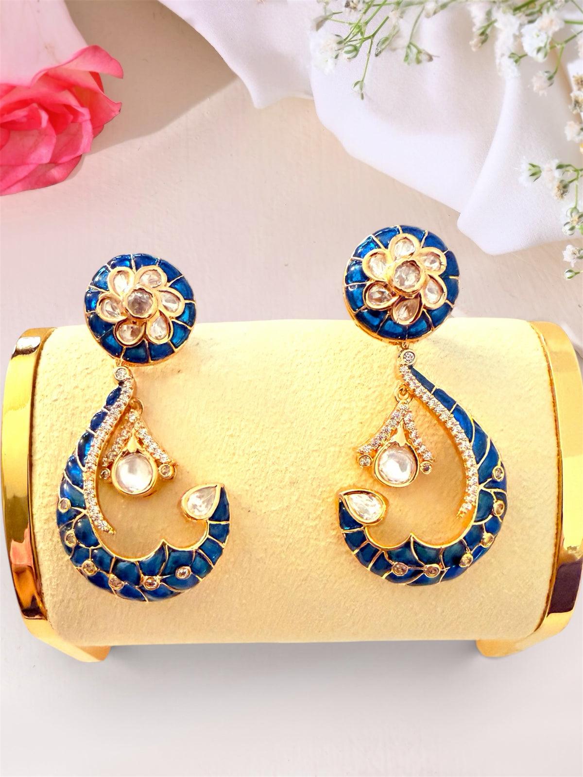 AISHI'S BOUTIQUE COLLECTION crescent drop earrings with blue enamel, gold-toned metal, and white stone floral accents.